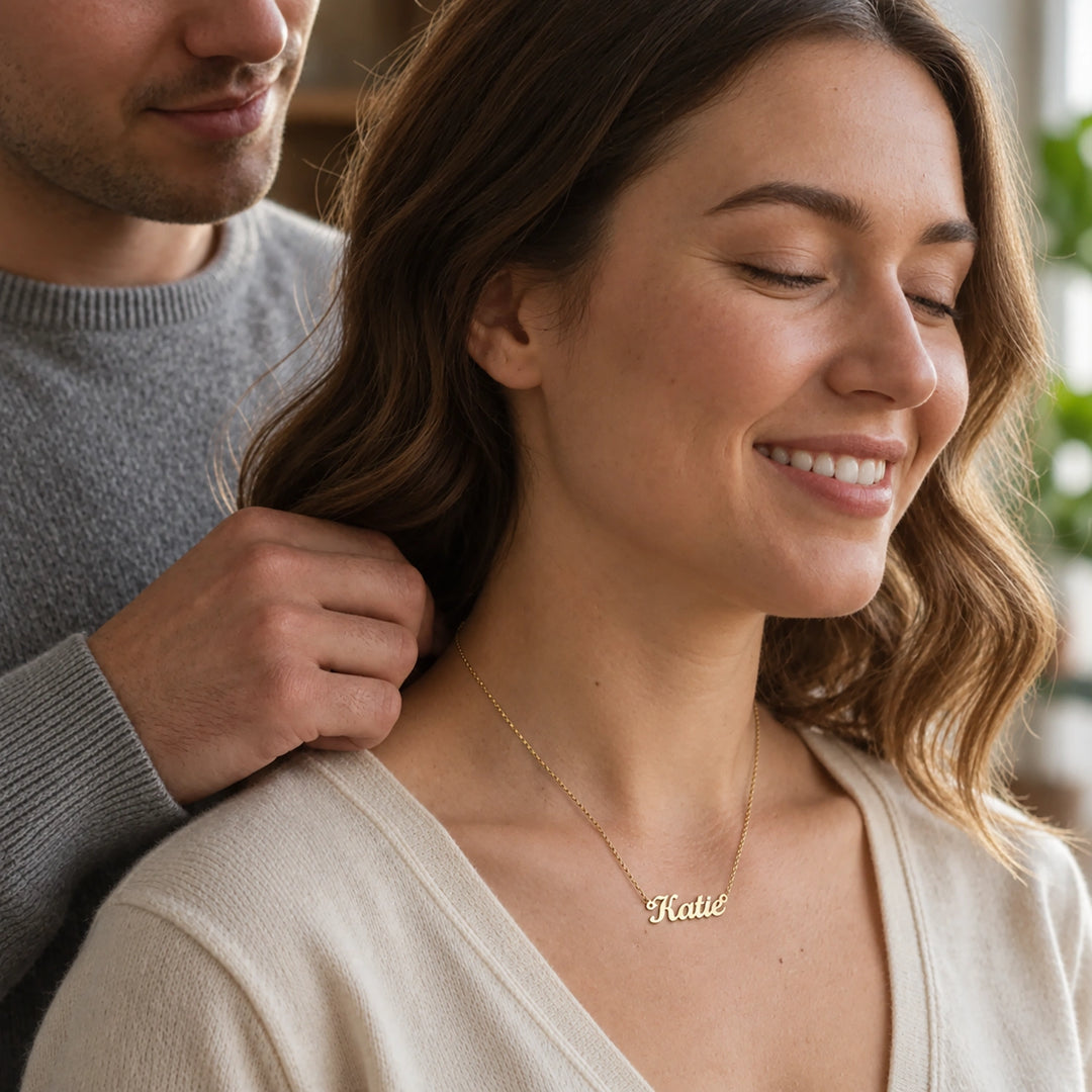 Man fastening the Name necklace on a smiling woman
