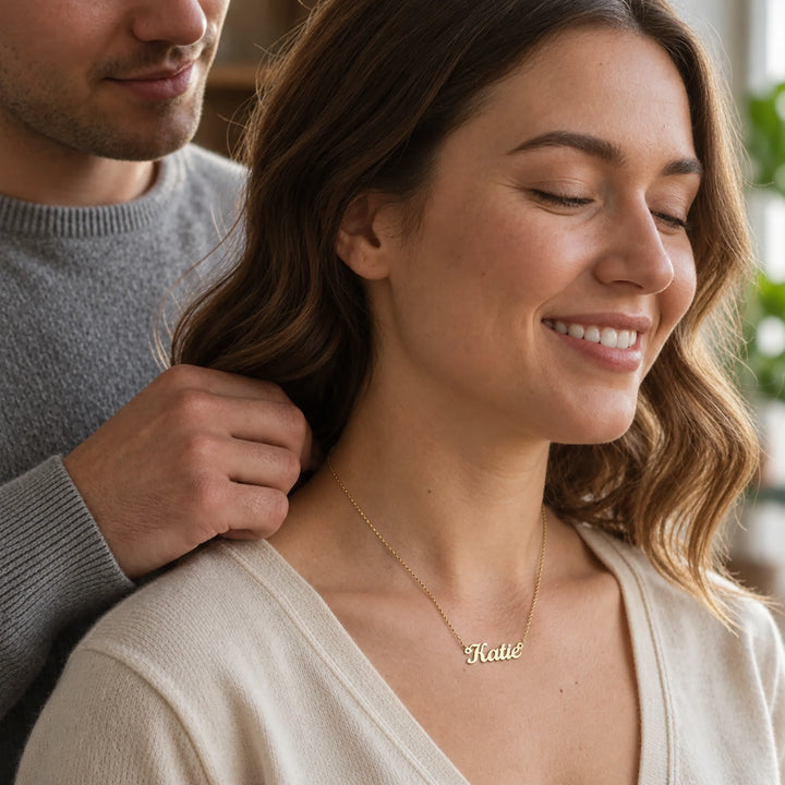 Man fastening the Name necklace on a smiling woman