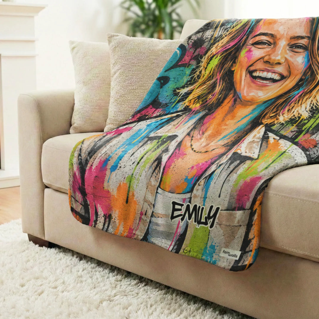 Graffiti blanket with the name Emily draped over a sofa