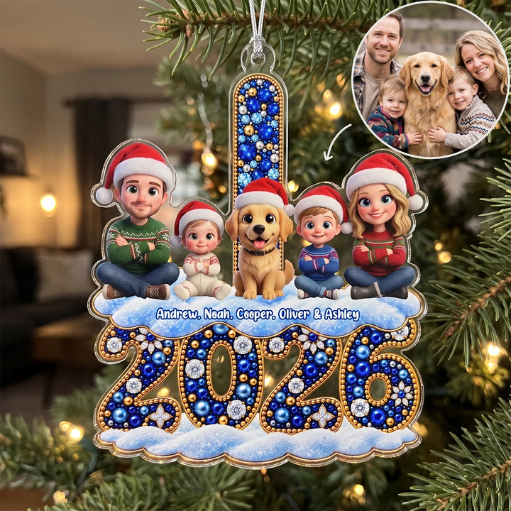 Personalized acrylic ornament "New Chapter 2026" with a family photo turned into 3D cartoon figures in Santa hats, a golden retriever and names above a jeweled 2026 on the Christmas tree