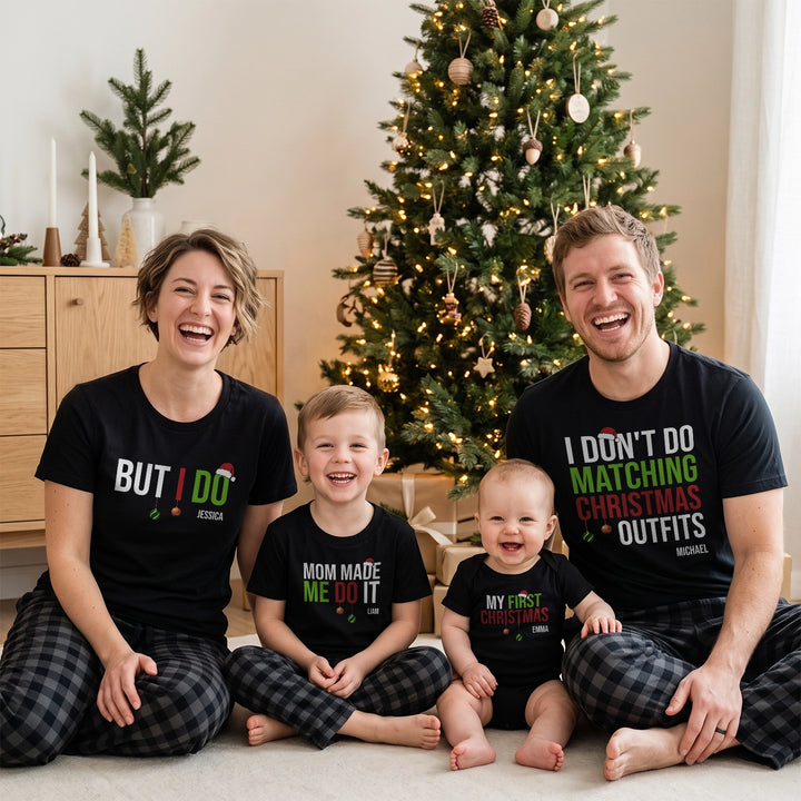 Personalized family Christmas shirts: parents, son and baby in matching black shirts with funny slogans and names by the Christmas tree