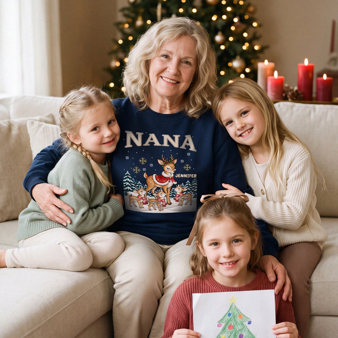 Grandma in a navy personalized NANA reindeer sweatshirt on the sofa with her three granddaughters