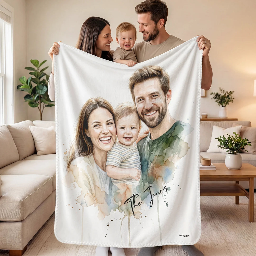 Parents with toddler holding up the family watercolor blanket in the living room