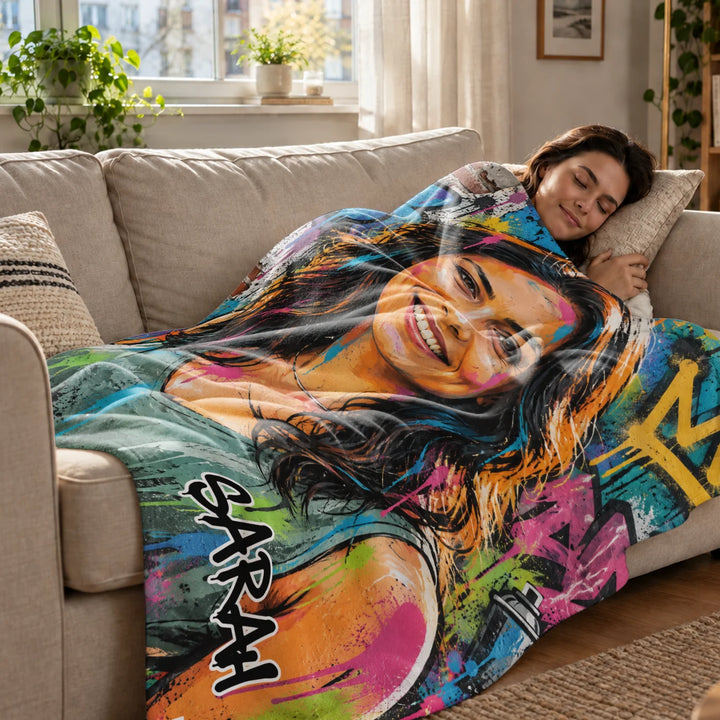 Woman relaxes on the sofa under her personalized street graffiti blanket