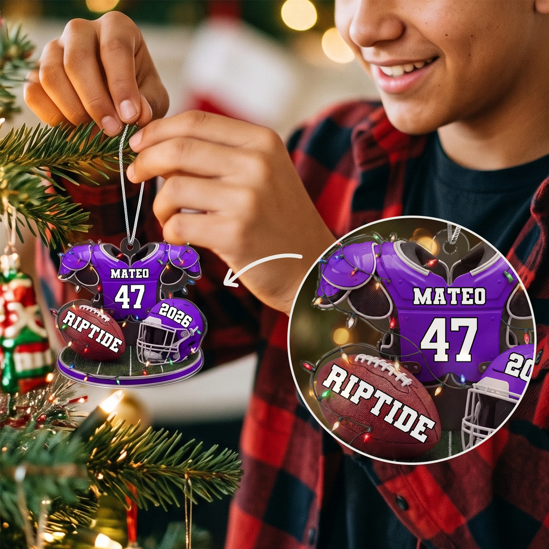 Teen hangs the purple Football ornament on the tree, close-up of name and number