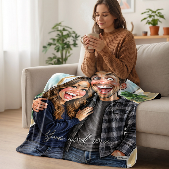 Woman with a cup on the sofa, couple sketch blanket spread over her lap