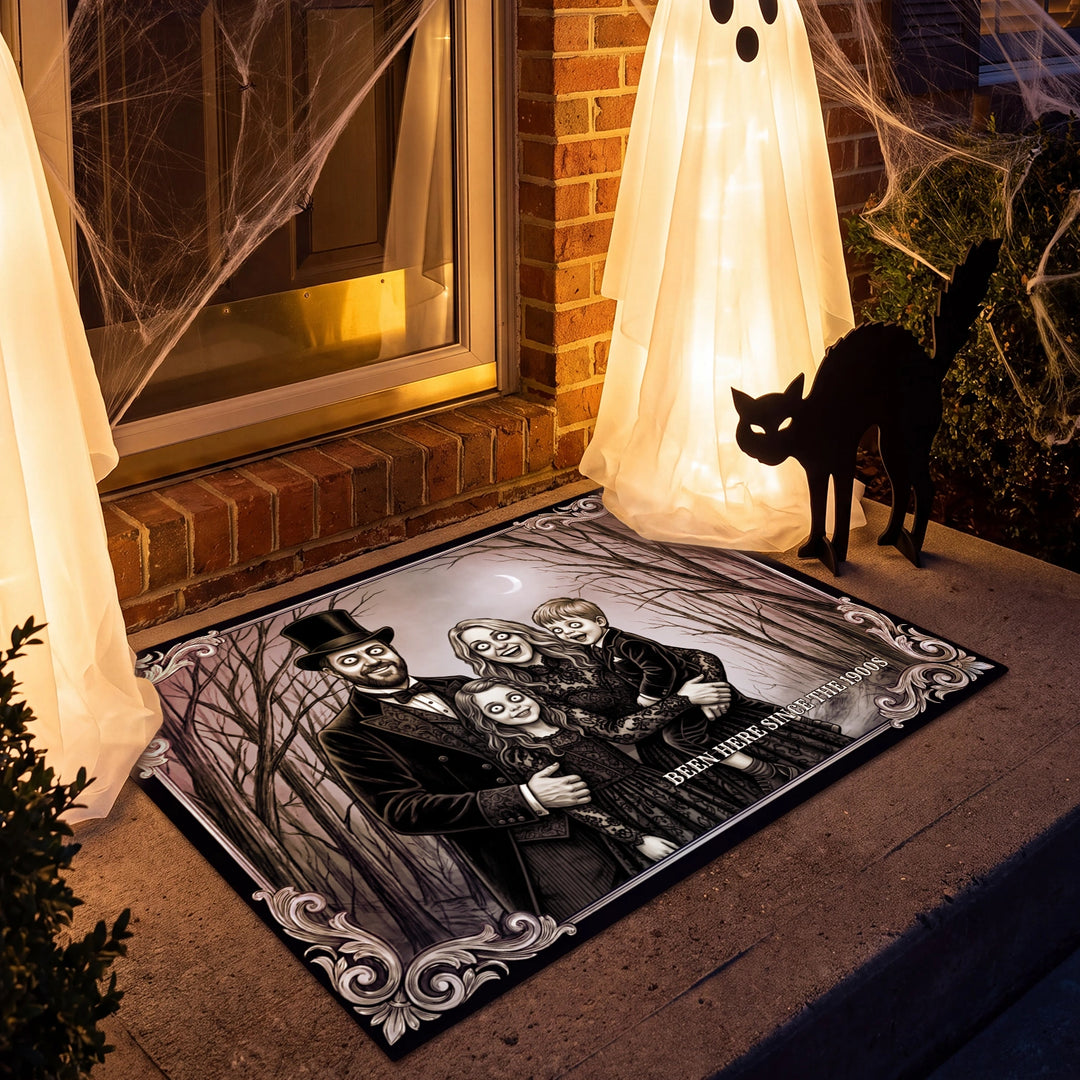 Halloween family photo doormat on a porch with ghost lanterns and a black cat