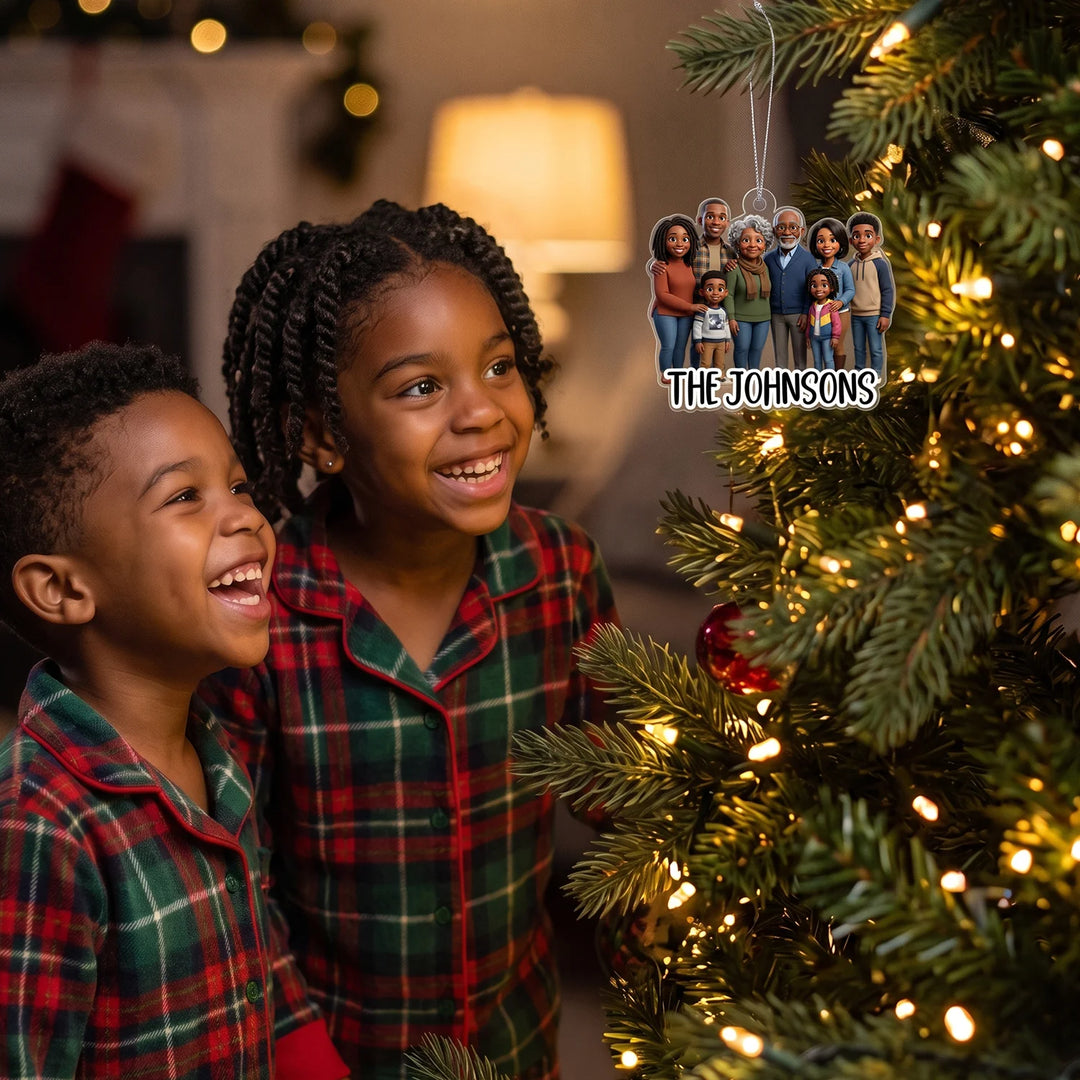 Two kids smiling at the Cartoon Portrait ornament with the name The Johnsons on the Christmas tree