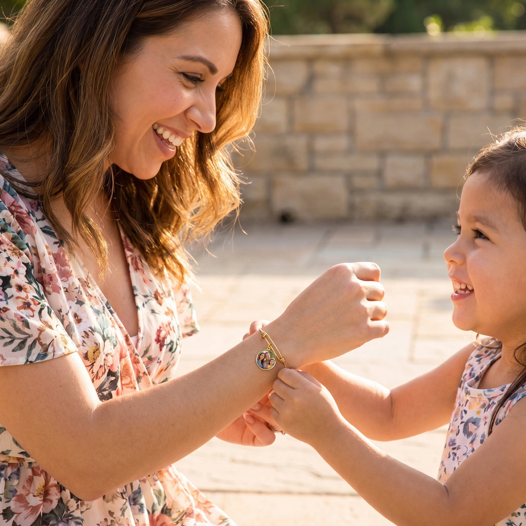 Mother and daughter laugh while holding hands with the Photo Circle bracelet