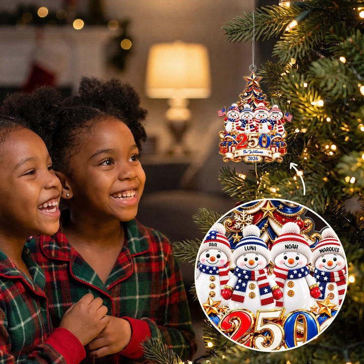 Two girls smiling at the Snowman 250 Years ornament with The Williams on the Christmas tree