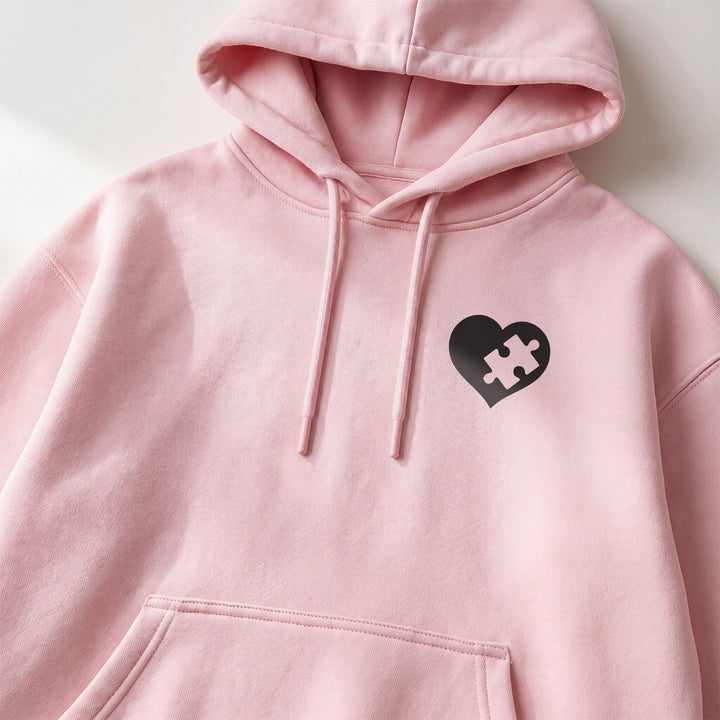 Close-up of the heart with missing puzzle piece on a pink hoodie