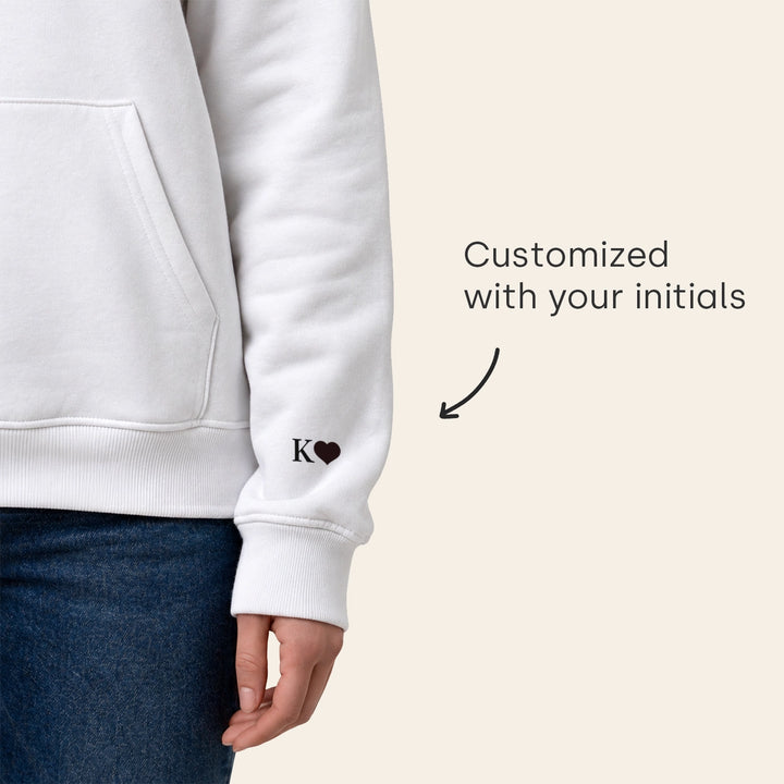 White hoodie sleeve customized with initials and a heart
