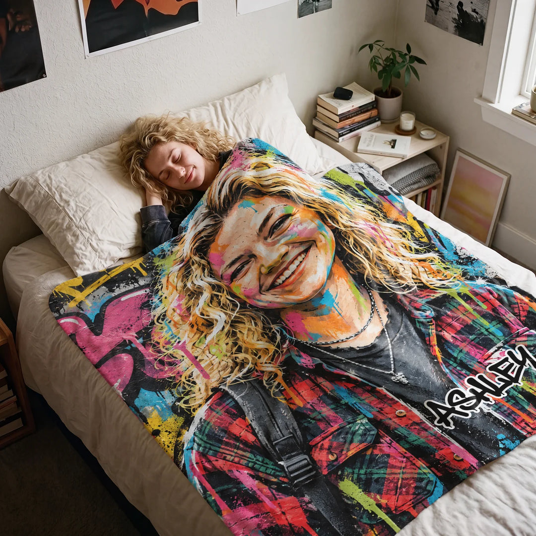 Woman sleeping in bed under a colorful graffiti blanket with the name Ashley
