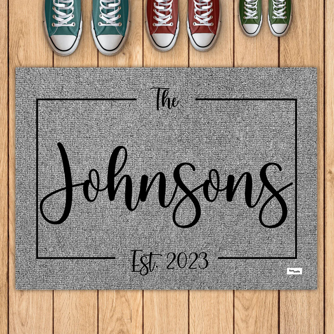 Gray family name doormat with sneakers lined up above it