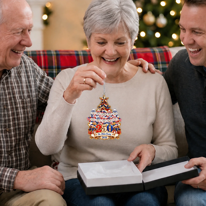 Grandma holding the Snowman 250 Years ornament of a big family next to an open gift box
