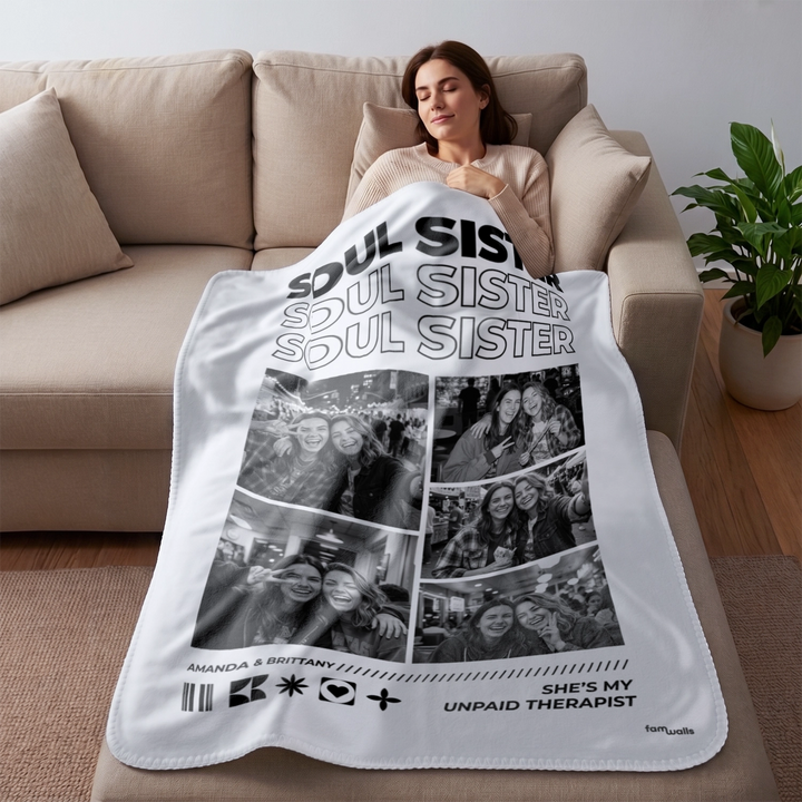 Woman resting on the sofa under a white Soul Sisters photo blanket
