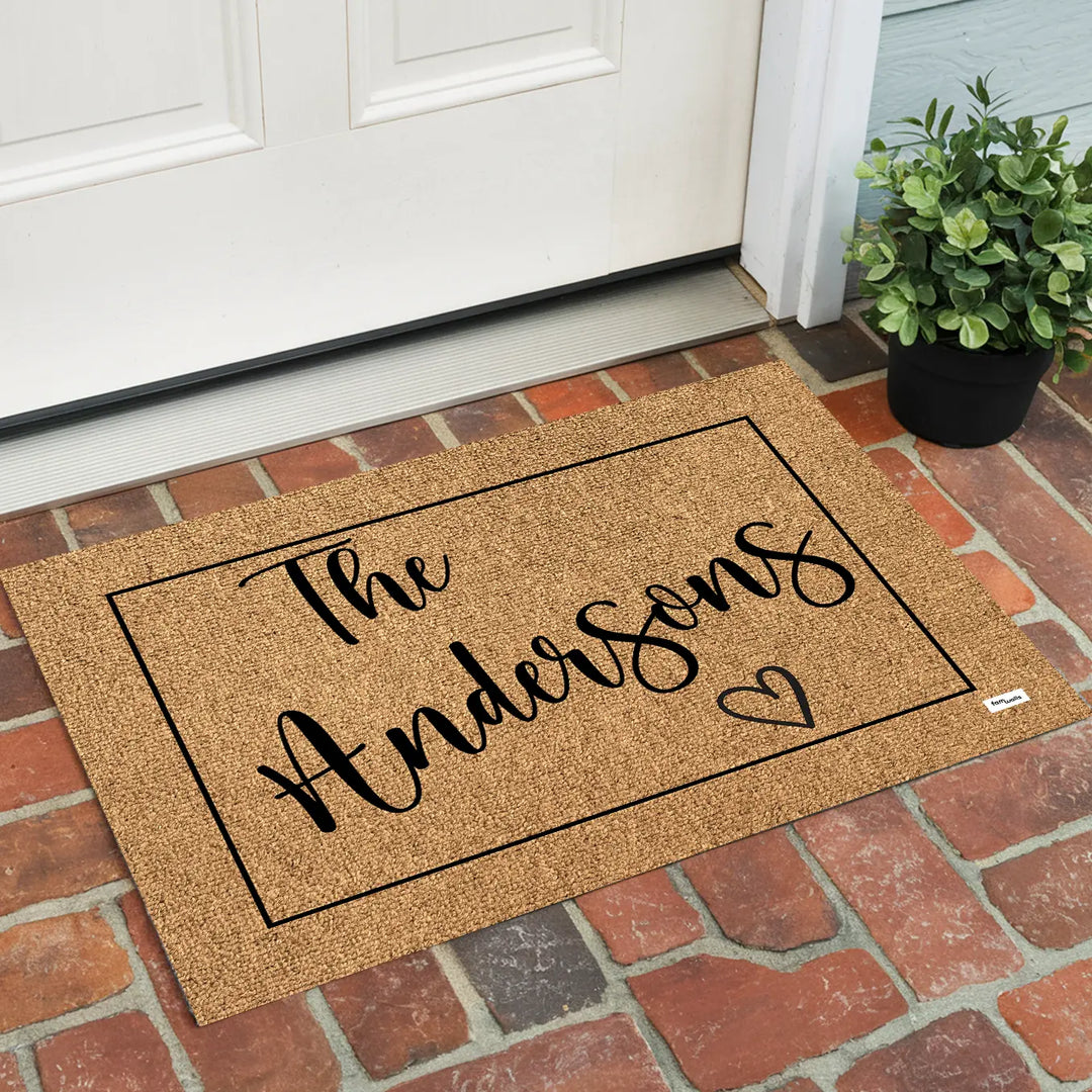 Brown family name doormat on a red brick porch